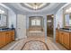 Light and airy bathroom featuring double vanities, a soaking tub, and a glass enclosed shower at 141 Dommerich Dr, Maitland, FL 32751