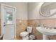 Compact half-bath features decorative tile and pedestal sink at 141 Dommerich Dr, Maitland, FL 32751