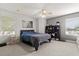 Comfortable bedroom featuring a gray accent wall, lots of natural light, and display shelves at 141 Dommerich Dr, Maitland, FL 32751