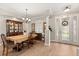 Elegant dining room with a large table, decorative lighting, and a display cabinet at 141 Dommerich Dr, Maitland, FL 32751
