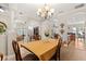 Elegant dining room space with detailed column architecture, chandelier and hardwood floors at 141 Dommerich Dr, Maitland, FL 32751