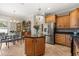 Bright kitchen with stainless steel refrigerator, wooden cabinets and a kitchen island at 141 Dommerich Dr, Maitland, FL 32751
