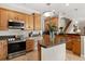 Spacious kitchen featuring stainless steel appliances, a cooktop, and center island at 141 Dommerich Dr, Maitland, FL 32751