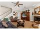 Cozy living room with a fireplace, ceiling fan, and a comfortable seating area for relaxing and entertaining at 141 Dommerich Dr, Maitland, FL 32751