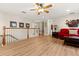 Inviting living space featuring wood floors, a red sofa, and white railing at 141 Dommerich Dr, Maitland, FL 32751