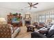 Comfortable living room with a fireplace, plantation shutters, and plenty of natural light and cozy furniture at 141 Dommerich Dr, Maitland, FL 32751