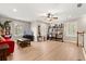 Open living room with wood floors, shuttered windows, and decorative shelving at 141 Dommerich Dr, Maitland, FL 32751
