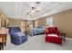 Spacious main bedroom featuring a tray ceiling, seating area, and access to the bath at 141 Dommerich Dr, Maitland, FL 32751