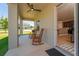 Relaxing back porch with rocking chairs and a ceiling fan overlooking the yard at 14537 San Lorenzo Dr, Orlando, FL 32820