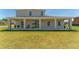 Spacious covered patio perfect for relaxation with rocking chairs and grill at 14537 San Lorenzo Dr, Orlando, FL 32820