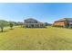 Well-maintained backyard showcasing a spacious lawn and a covered patio, ideal for outdoor activities at 14537 San Lorenzo Dr, Orlando, FL 32820