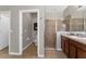 Bathroom featuring a shower with glass doors, a vanity with dark wood cabinets, and a neutral color scheme at 14537 San Lorenzo Dr, Orlando, FL 32820