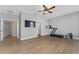 Spacious bedroom with wood floors, TV, and gym equipment, offering flexibility for relaxation and exercise at 14537 San Lorenzo Dr, Orlando, FL 32820