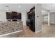 Stylish kitchen featuring dark wood cabinets, a decorative backsplash, and sleek black appliances at 14537 San Lorenzo Dr, Orlando, FL 32820
