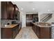 Well-equipped kitchen with dark cabinetry, granite counters, tiled backsplash, and stainless appliances at 14537 San Lorenzo Dr, Orlando, FL 32820