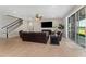 Inviting living room with tile flooring, staircase, and sliding glass doors to the outdoor area at 14537 San Lorenzo Dr, Orlando, FL 32820