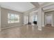 Spacious open living area with neutral walls and tile flooring, leading to additional rooms at 14537 San Lorenzo Dr, Orlando, FL 32820