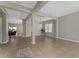 Bright, open-concept living area with tile flooring, neutral paint, and elegant support beams at 14537 San Lorenzo Dr, Orlando, FL 32820