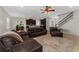 Open living space showcasing dark furniture, tile floors, stairs, and a view of the kitchen at 14537 San Lorenzo Dr, Orlando, FL 32820