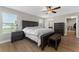 Main bedroom featuring wood floors, a large bed, natural light, and an ensuite bathroom at 14537 San Lorenzo Dr, Orlando, FL 32820