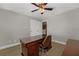Bright home office features a ceiling fan and a lovely wood desk with chair at 14537 San Lorenzo Dr, Orlando, FL 32820