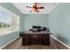 A home office featuring a large desk, ceiling fan, and a bright window for a productive work environment at 14537 San Lorenzo Dr, Orlando, FL 32820
