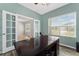 Home office featuring french doors, a large desk, and a bright window for a professional and inviting workspace at 14537 San Lorenzo Dr, Orlando, FL 32820