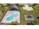 Aerial view of a community pool, playground, and clubhouse at 14537 San Lorenzo Dr, Orlando, FL 32820