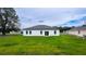 Picture of a backyard with a white home featuring nice landscaping at 16734 Sw 18Th Avenue Rd, Ocala, FL 34473
