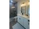Modern bathroom with double sinks, white cabinets, and a glass-enclosed shower at 16734 Sw 18Th Avenue Rd, Ocala, FL 34473