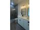 Modern bathroom featuring a glass-enclosed shower, double sink vanity with stone countertops, and contemporary lighting at 16734 Sw 18Th Avenue Rd, Ocala, FL 34473