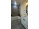 Modern bathroom featuring gray tiling, a white vanity, and sleek black hardware fixtures at 16734 Sw 18Th Avenue Rd, Ocala, FL 34473