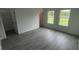 Spacious bedroom featuring gray flooring, neutral walls, and plenty of natural light at 16734 Sw 18Th Avenue Rd, Ocala, FL 34473