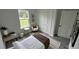 Comfortable bedroom with a large window, closet, neutral decor, and wood-look floors at 16734 Sw 18Th Avenue Rd, Ocala, FL 34473