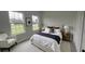 Inviting bedroom with large windows, neutral colors, and wood-look flooring at 16734 Sw 18Th Avenue Rd, Ocala, FL 34473