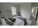 Cozy bedroom with closet, a large window, neutral walls, and wood-look flooring at 16734 Sw 18Th Avenue Rd, Ocala, FL 34473