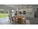 Beautiful dining area featuring a large wood table, pendant lighting, and stainless steel appliances at 16734 Sw 18Th Avenue Rd, Ocala, FL 34473