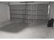 Empty garage with paneled garage door and concrete floor ready for storage or parking at 16734 Sw 18Th Avenue Rd, Ocala, FL 34473