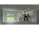 Open kitchen with stainless steel appliances, island with sink, and sliding glass doors at 16734 Sw 18Th Avenue Rd, Ocala, FL 34473
