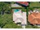 Aerial shot showcases the pool in a beautifully landscaped backyard, surrounded by mature trees and well-maintained residences at 1855 Vista Royale Blvd, Orlando, FL 32835