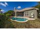 Charming backyard featuring a pristine pool, complemented by the home's neutral exterior and cozy patio space at 1855 Vista Royale Blvd, Orlando, FL 32835