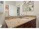 Close-up of a bathroom vanity with granite countertop and wooden cabinets at 1855 Vista Royale Blvd, Orlando, FL 32835