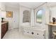 Elegant bathroom featuring a soaking tub, granite countertops, and a tiled floor at 1855 Vista Royale Blvd, Orlando, FL 32835