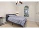 Comfortable bedroom featuring an arched window offering natural light and a ceiling fan at 1855 Vista Royale Blvd, Orlando, FL 32835