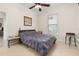 Comfortable bedroom with a gray comforter, light wood floors, and a classic ceiling fan at 1855 Vista Royale Blvd, Orlando, FL 32835