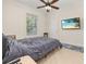 Cozy bedroom with a ceiling fan and a large window, offering ample light and comfort at 1855 Vista Royale Blvd, Orlando, FL 32835
