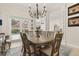 Charming dining area with wooden table, chandelier and view into the kitchen at 1855 Vista Royale Blvd, Orlando, FL 32835