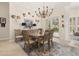 Bright dining room with elegant chandelier and sliding glass door to the backyard at 1855 Vista Royale Blvd, Orlando, FL 32835
