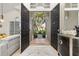 Open foyer with double doors, neutral decor, and view of the lush front yard at 1855 Vista Royale Blvd, Orlando, FL 32835