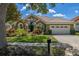 Charming single-story home with tile roof, lush landscaping, and a two-car garage at 1855 Vista Royale Blvd, Orlando, FL 32835